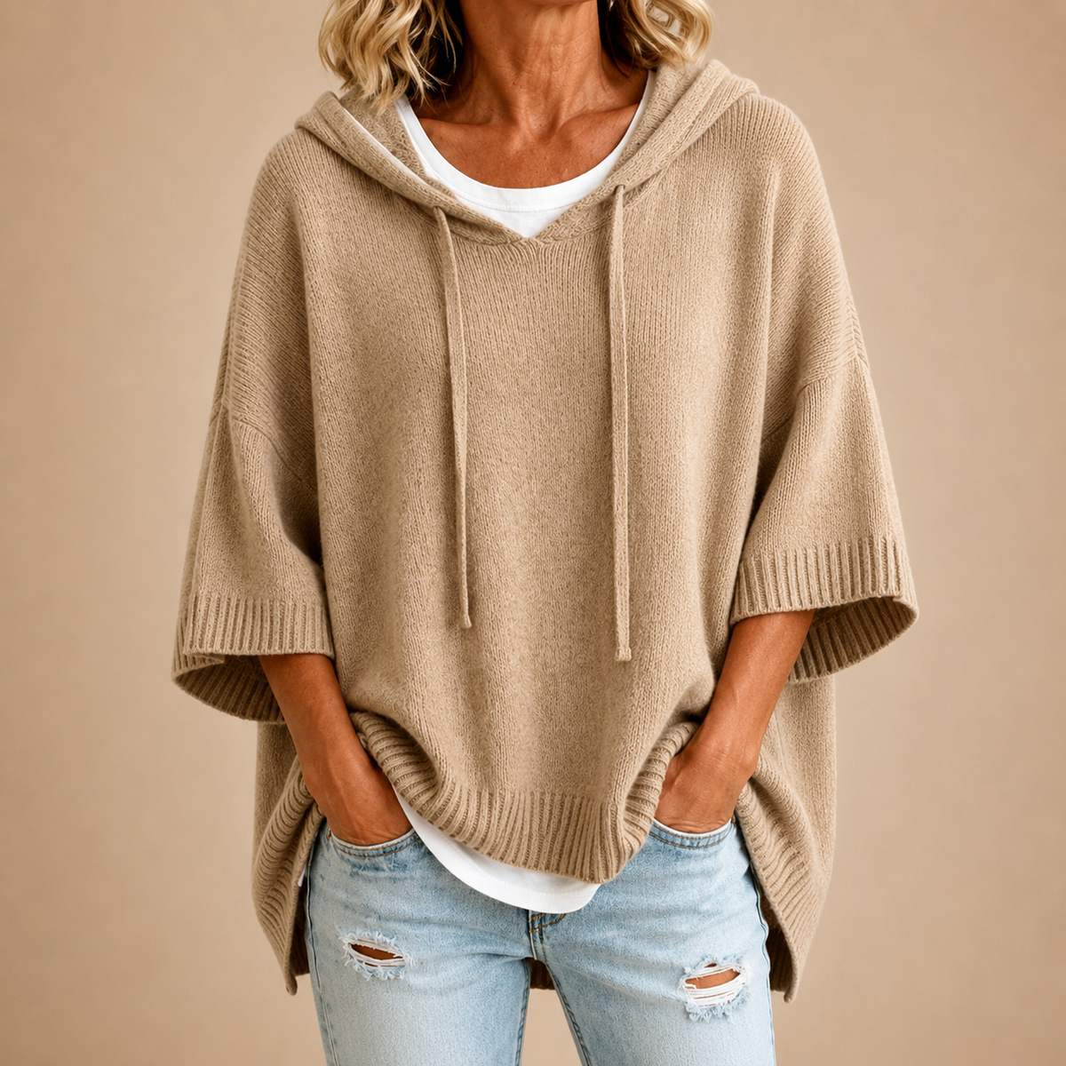 Orielle | Poncho-style knitted sweater with hood and three-quarter sleeves.